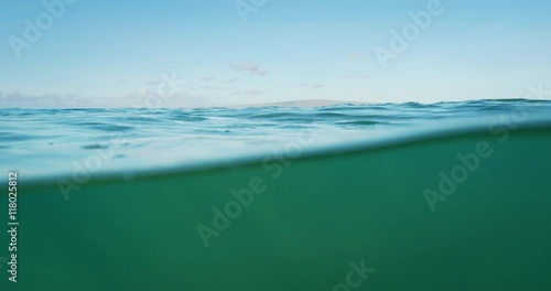 Beautiful blue ocean, over under split view of sky and underwater photo