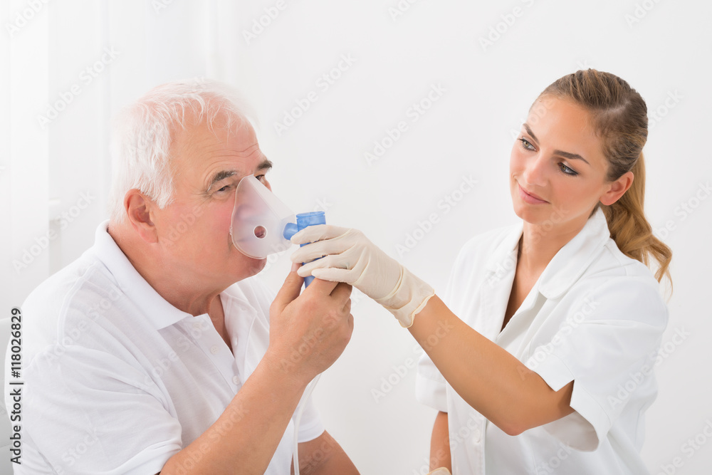 Obraz premium Patient Inhaling Through Oxygen Mask