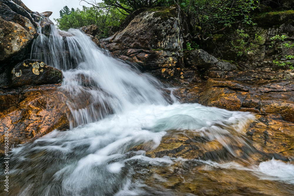 Fototapeta premium small waterfall on the Kamenka river in Khamar-Daban ridge