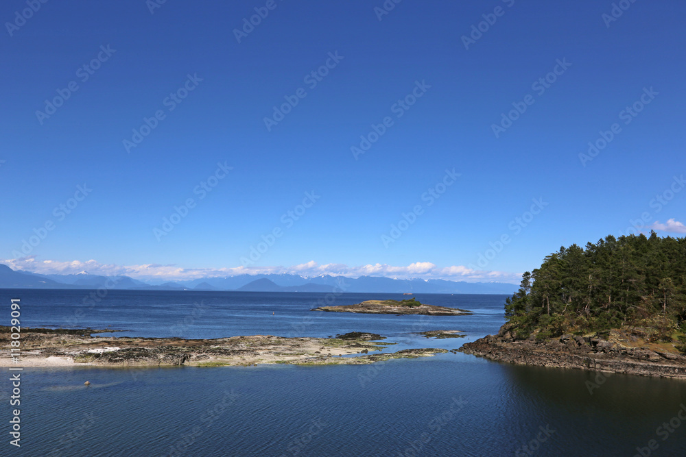 A view of mainland from the coast of Gabriola Island, just off Vancouver Island, British Columbia, Canada.. A view of mainland from the coast of Gabriola Island, just off Vancouver Island, British Columbia, Canada..