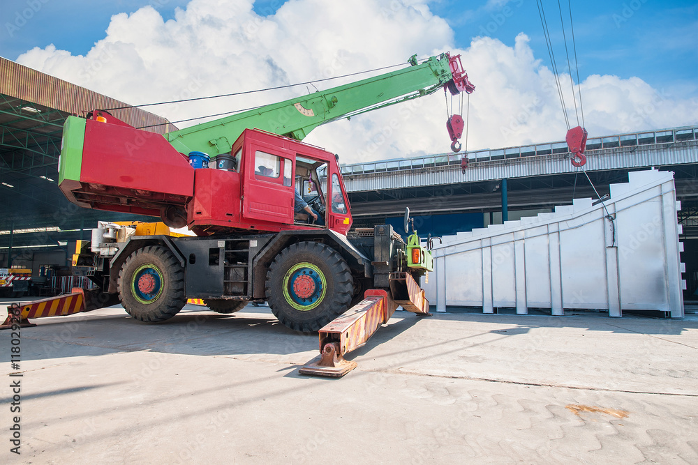 Mobile crane lifting and moving an heavy electric generator Mobile crane lifting and moving an heavy electric generator