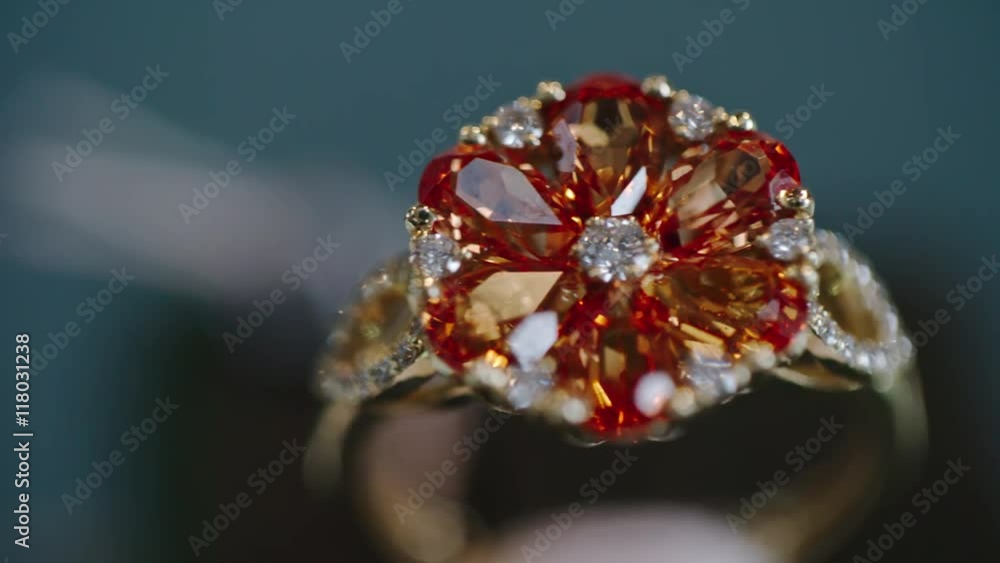 Closeup of beautiful ruby and diamond flower ring in gold Closeup of beautiful ruby and diamond flower ring in gold