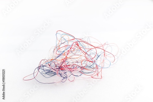 tangled colored thread on a white background,selective focus