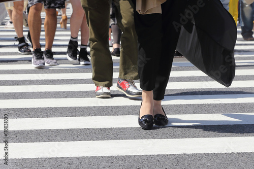 unidentified people legs crossing street