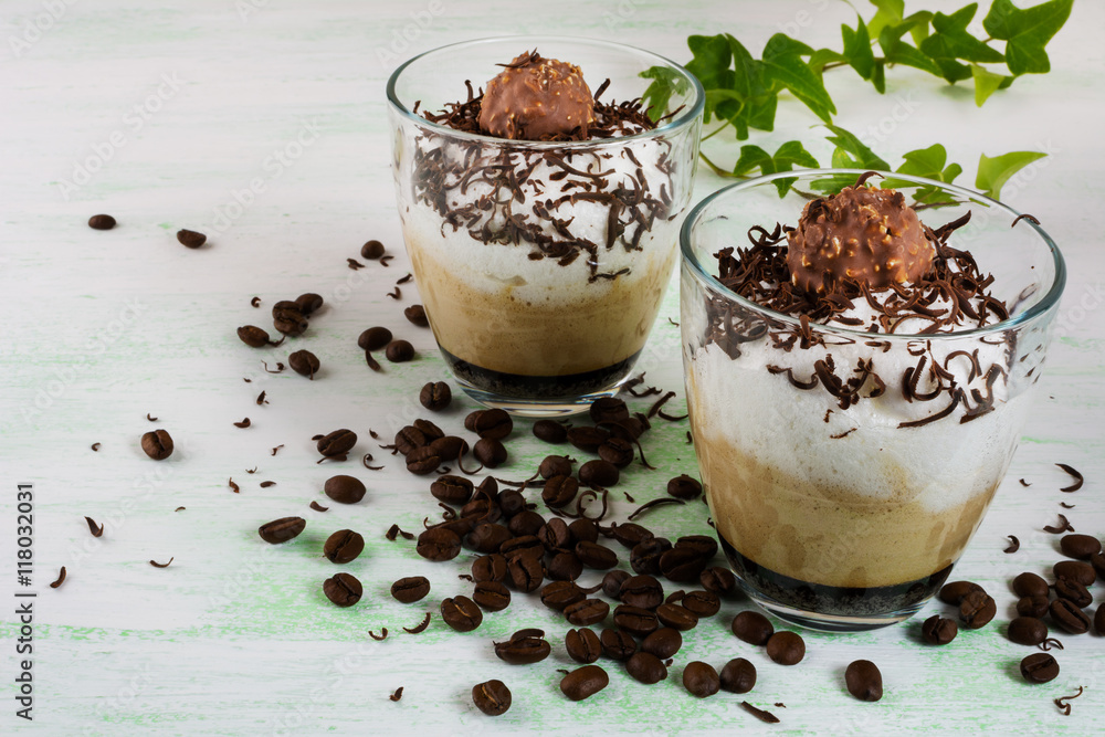 Chocolate milkshake with whipped cream on light green background Chocolate milkshake with whipped cream on light green background