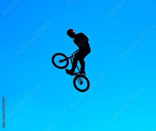Silhouette image of a cyclist on the background of the sky