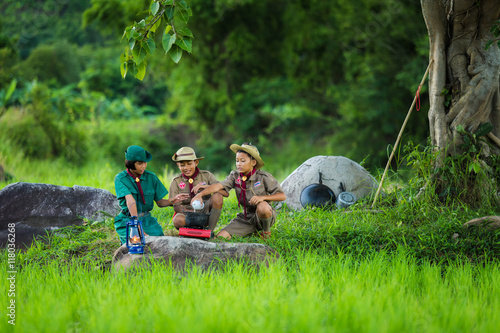 Boy Scout and girl scout in Camp to help themselves to the food as part of the study. photo