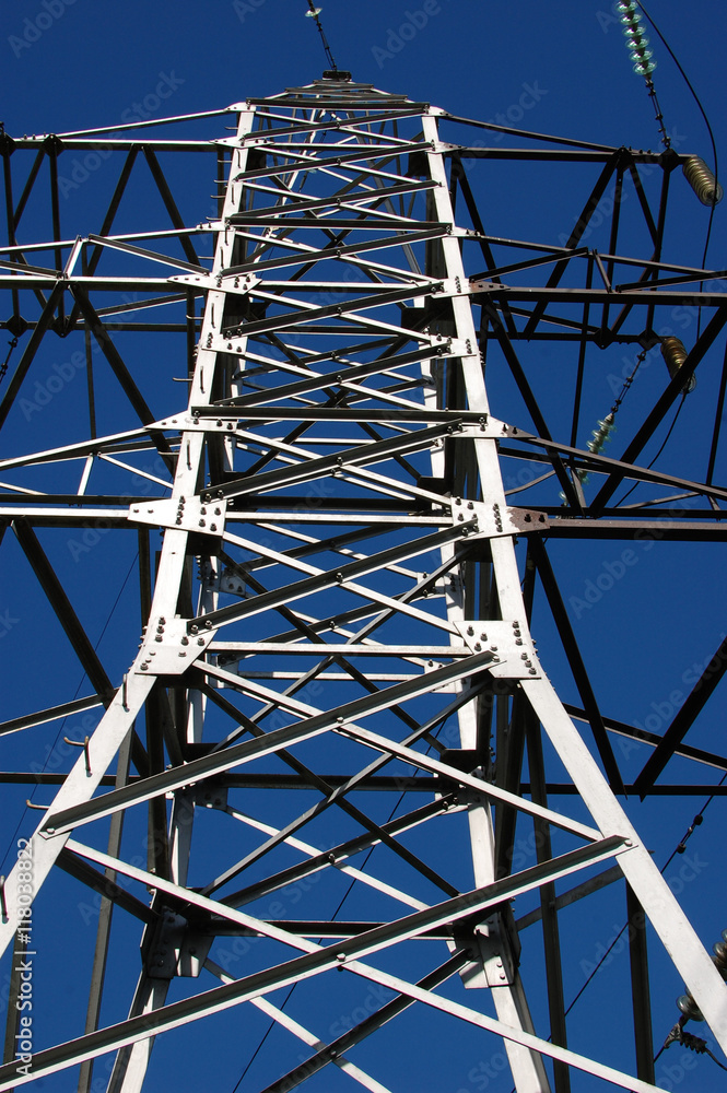 Close up tower power line against clear blue sky