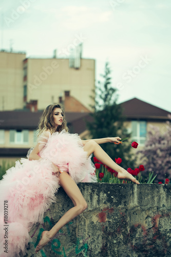 Fashionable woman near red tulips