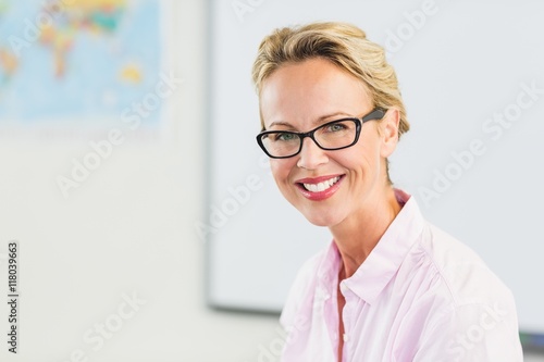 Portrait of teacher smiling in classroom