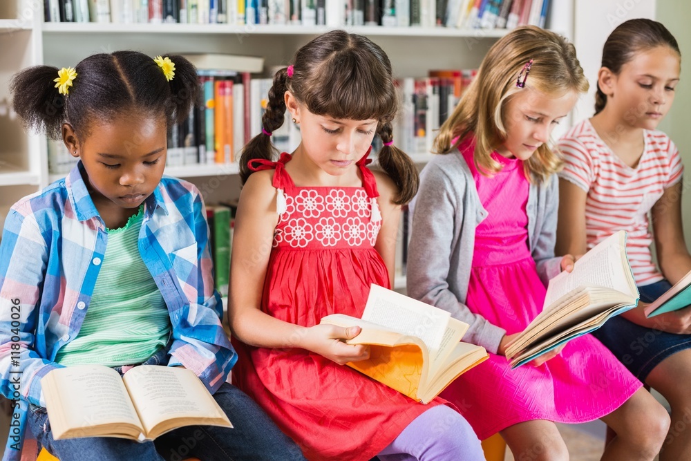Kids reading a book in library Kids reading a book in library
