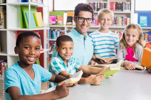 Portrait of teacher and kids in library