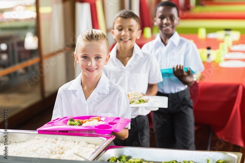 Portrait of school kids having lunch during break time  photo