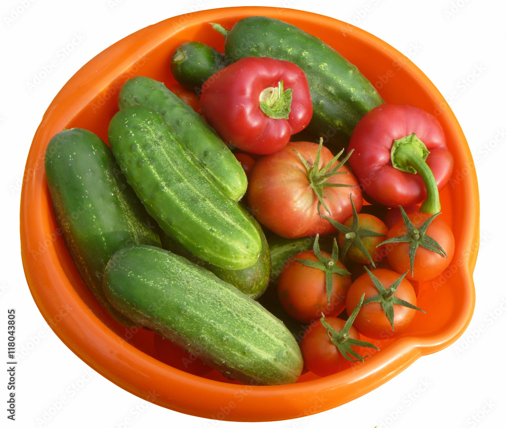 Tomatoes,cucumber and pepper in orange plate Tomatoes,cucumber and pepper in orange plate