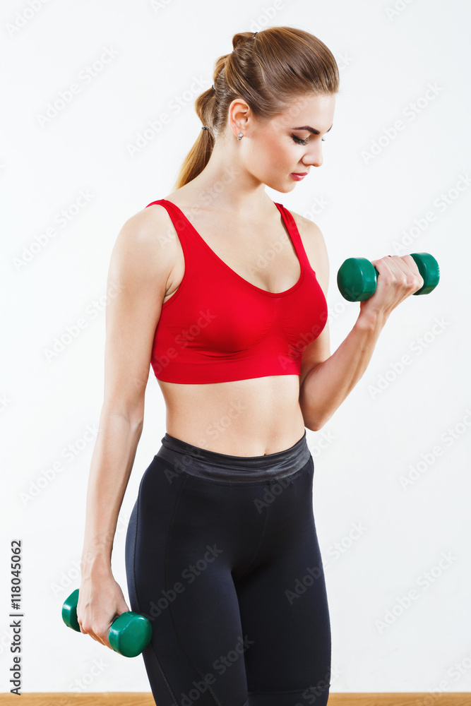 Attractive fit girl doing physical exercises at gym Attractive fit girl doing physical exercises at gym