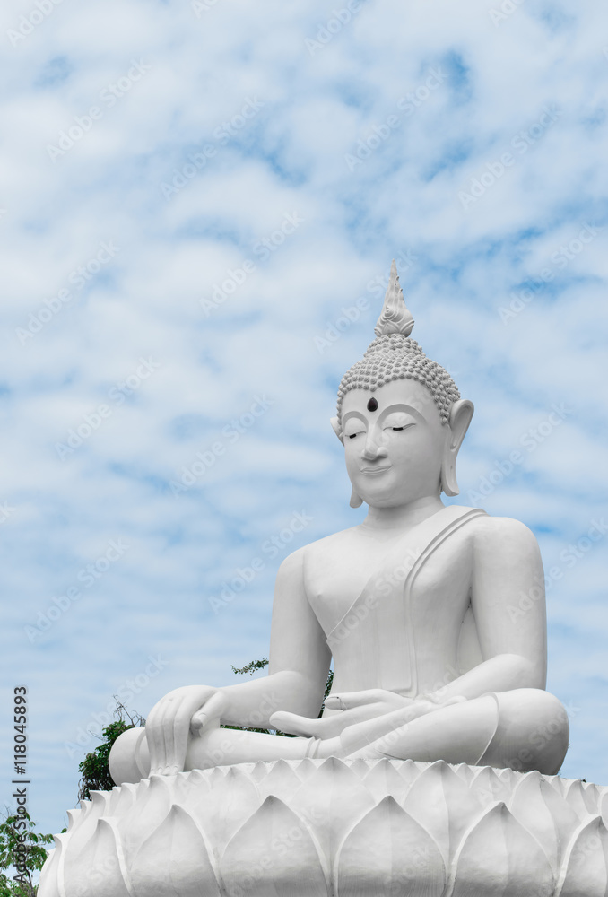 Big white statue of Buddha from back on blue sky Big white statue of Buddha from back on blue sky