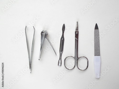 Nail file, cuticles remover, scissors, clipper nail and tweezers on white background