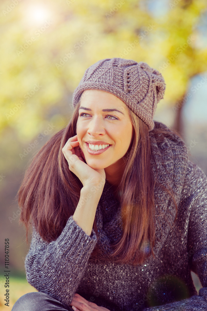 Autumn in park,Young smiling woman relaxing in nature Autumn in park,Young smiling woman relaxing in nature