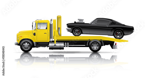 yellow truck towing black muscle car