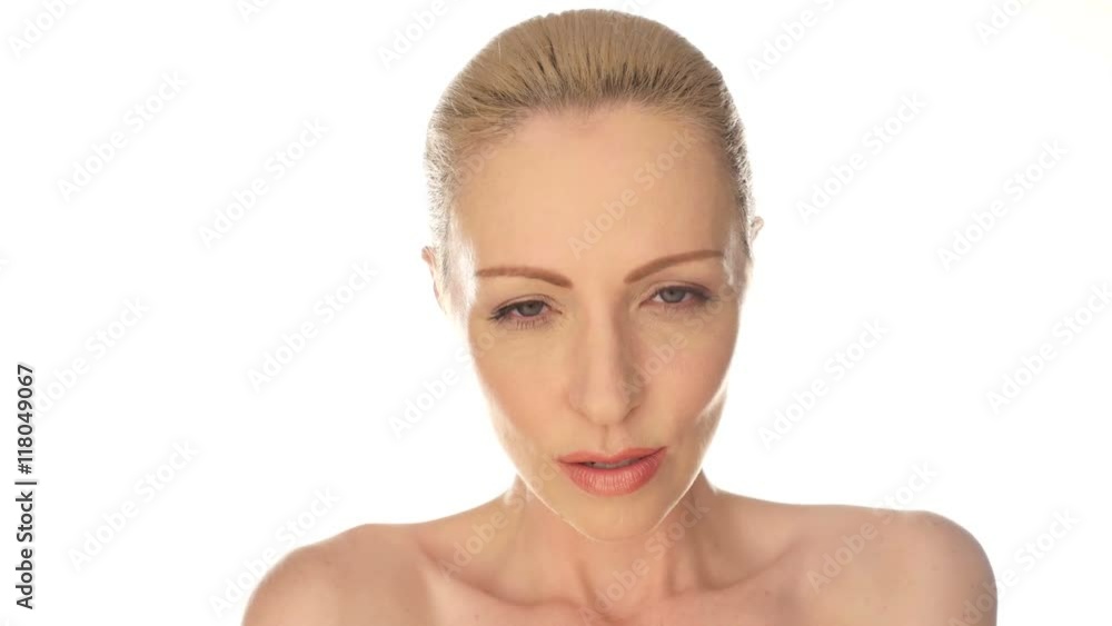 Close up Seductive Bare Middle Age Woman with Hand Touching on Face While Looking at the Camera. Isolated on White Background.