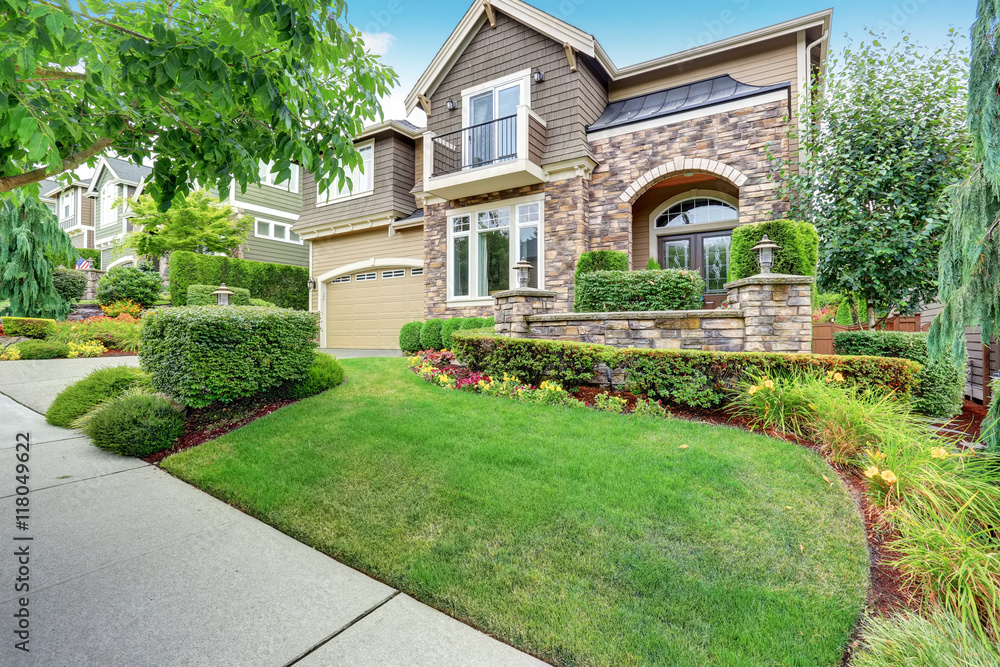 Beautiful curb appeal of American house with stone trim