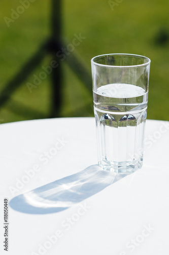 Wallpaper Mural Glass of water lightened with sun on a white table Torontodigital.ca
