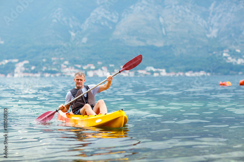 Mature man kayaking on the sea © Mediteraneo