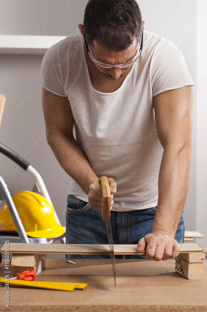 Worker works with handsaw Worker works with handsaw