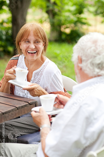 Senior couple enjoying cup of coffee outdoors
