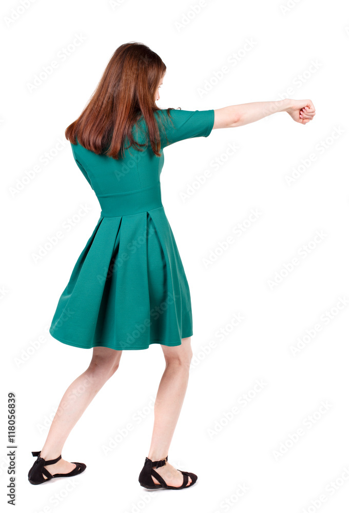 skinny woman funny fights waving his arms and legs. Isolated over white background. The slender brunette in a green short dress has outstretched arm. skinny woman funny fights waving his arms and legs. Isolated over white background. The slender brunette in a green short dress has outstretched arm.