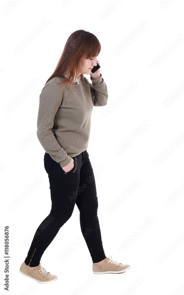 side view of a woman walking with a mobile phone. back view of girl in motion. backside view of person. Rear view people collection. Isolated over white background. with his hand in the pocket of a side view of a woman walking with a mobile phone. back view of girl in motion. backside view of person. Rear view people collection. Isolated over white background. with his hand in the pocket of a