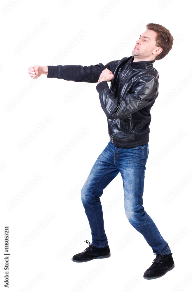 back view of guy funny fights waving his arms and legs. Isolated over white  background. Rear view people collection. backside view of  guy  in a black leather jacket clumsily fighting. Stock