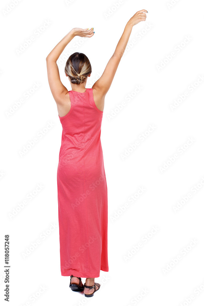 back view of dancing young beautiful woman. girl watching. Rear view people collection. backside view of person. Isolated over white background.A slender woman in a long red is raising his arms up back view of dancing young beautiful woman. girl watching. Rear view people collection. backside view of person. Isolated over white background.A slender woman in a long red is raising his arms up