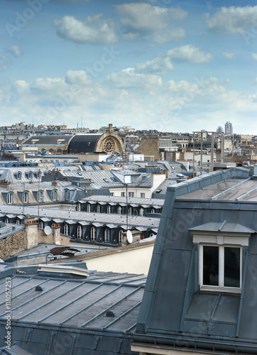 Parisian mansard window and panorama view of Paris rooftops