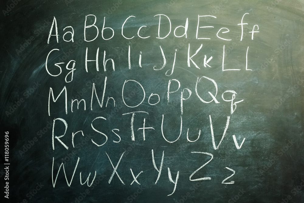 The alphabet written with white chalk on a blackboard The alphabet written with white chalk on a blackboard