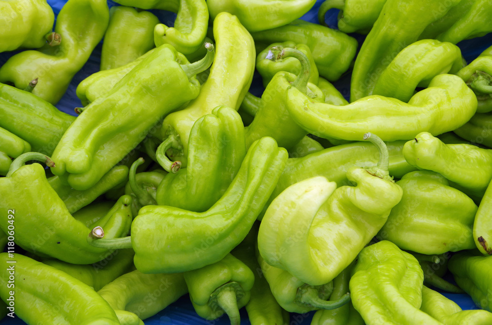 Bright green chili peppers for market displayed on light blue Bright green chili peppers for market displayed on light blue