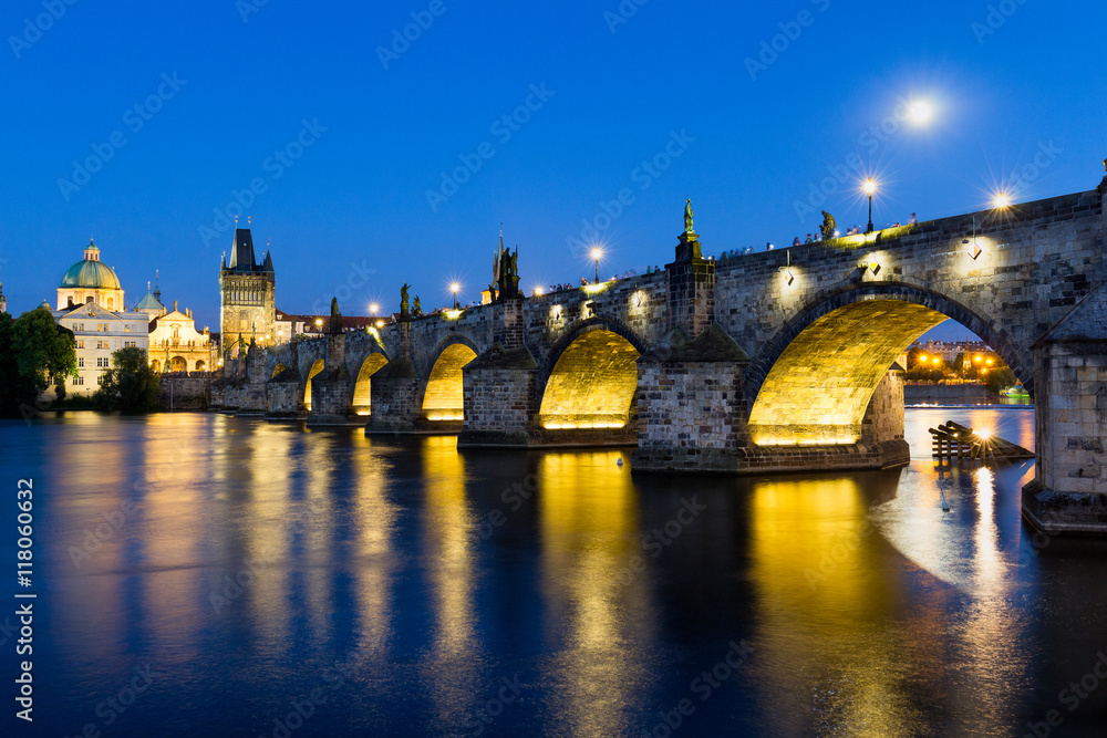 The historic center of Prague, ancient architecture and cultural heritage. Charles Bridge at night to the river. Czech Republic