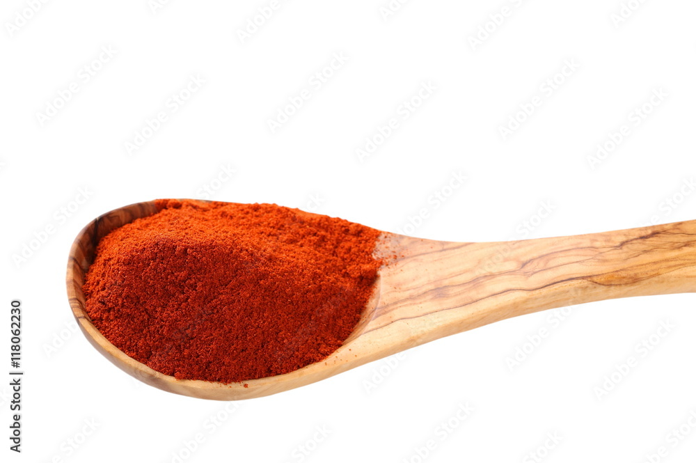 paprika powder and wooden spoon isolated on white, red spices paprika powder and wooden spoon isolated on white, red spices