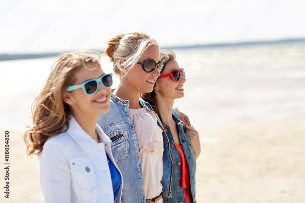 group of smiling women in sunglasses on beach group of smiling women in sunglasses on beach