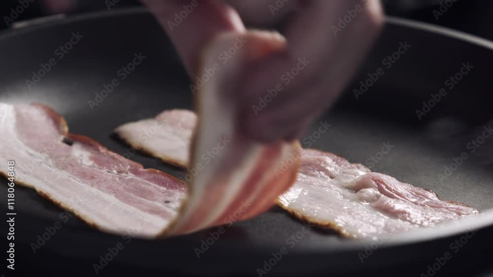 bacon roasting on a pan closeup 180fps slow motion bacon roasting on a pan closeup 180fps slow motion