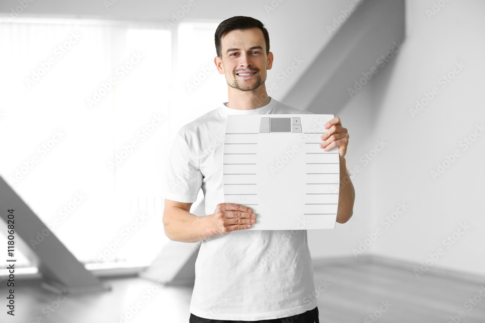 Man holding weight scale