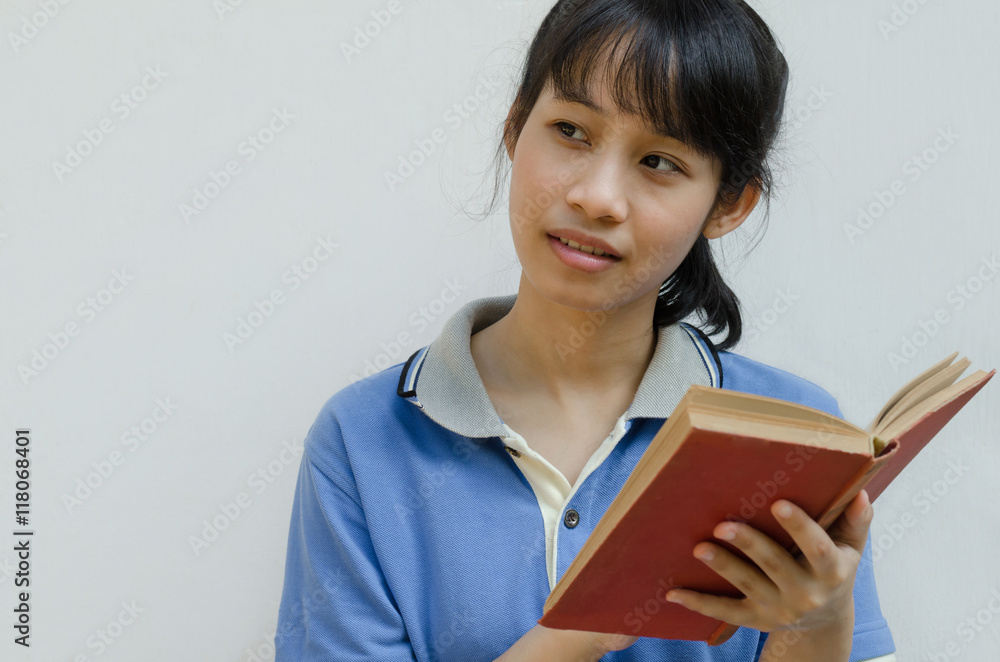 Asian Teenager Girl Thinking When Reading A Book. Asian Teenager Girl Thinking When Reading A Book.