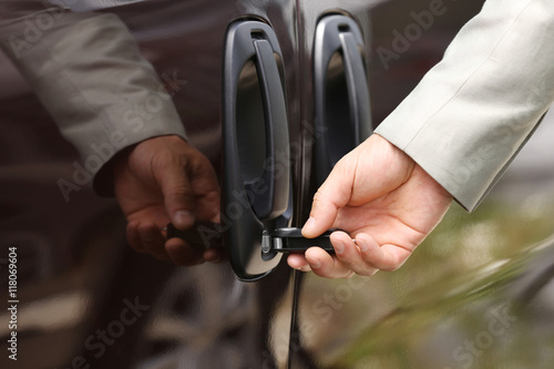 Male hand opening car door with key