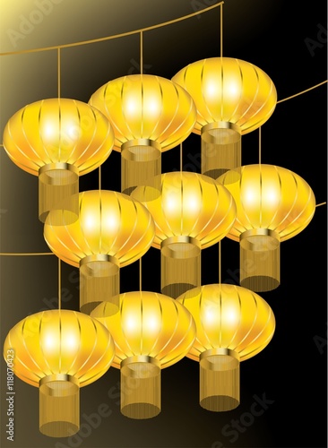 Beautiful golden lanterns hanging on strings on black background