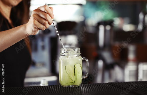 Woman hands making cocktail on bar counter