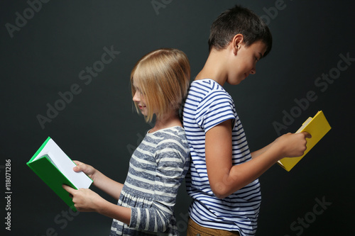 Cute boy and girl reading b...