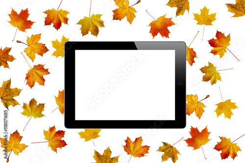 Black tablet with empty screen on pattern with autumn color mapl photo