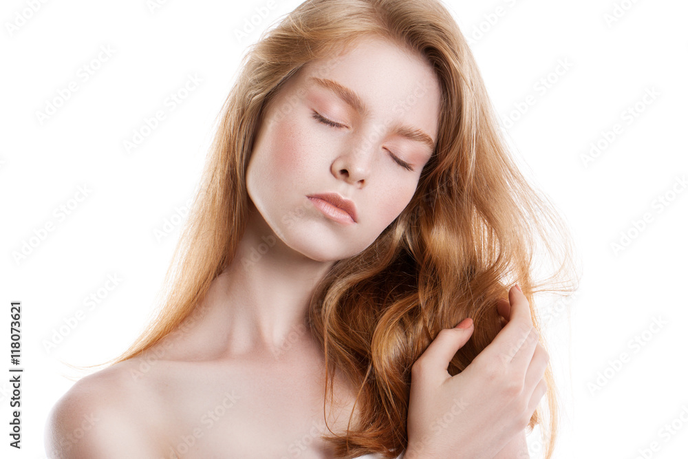 Portrait of a young red-haired girl on a white background. Portrait of a young red-haired girl on a white background.