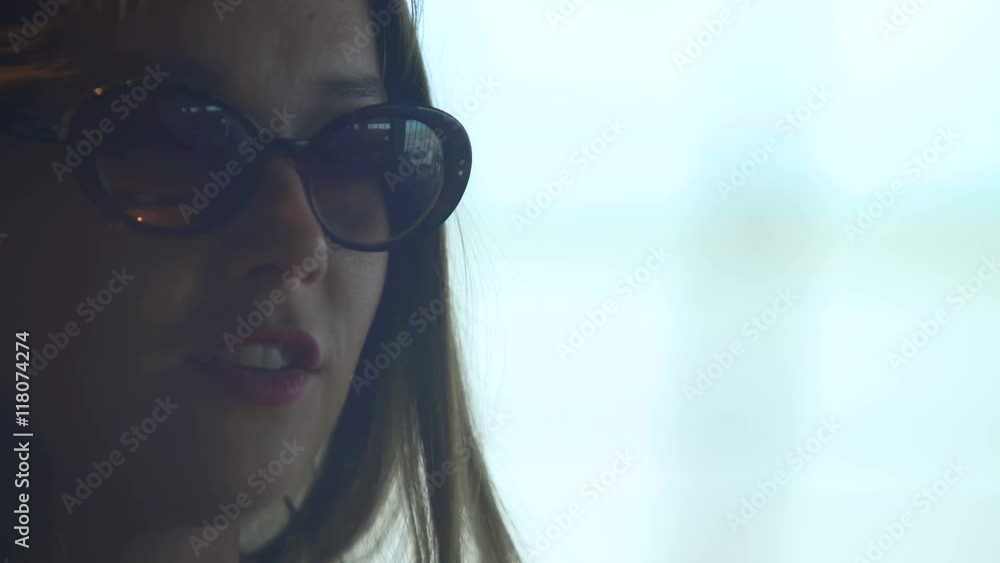 Beautiful smiling woman in sunglasses talking, face closeup, positive emotions Beautiful smiling woman in sunglasses talking, face closeup, positive emotions