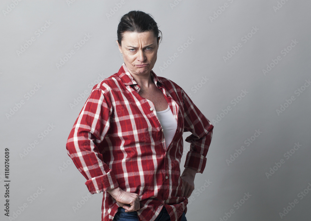 frowning tomboy mature woman showing her disagreement frowning tomboy mature woman showing her disagreement